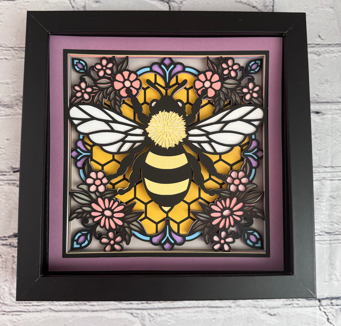 Colorful bee stained glass look 3D paper art in a shadowbox