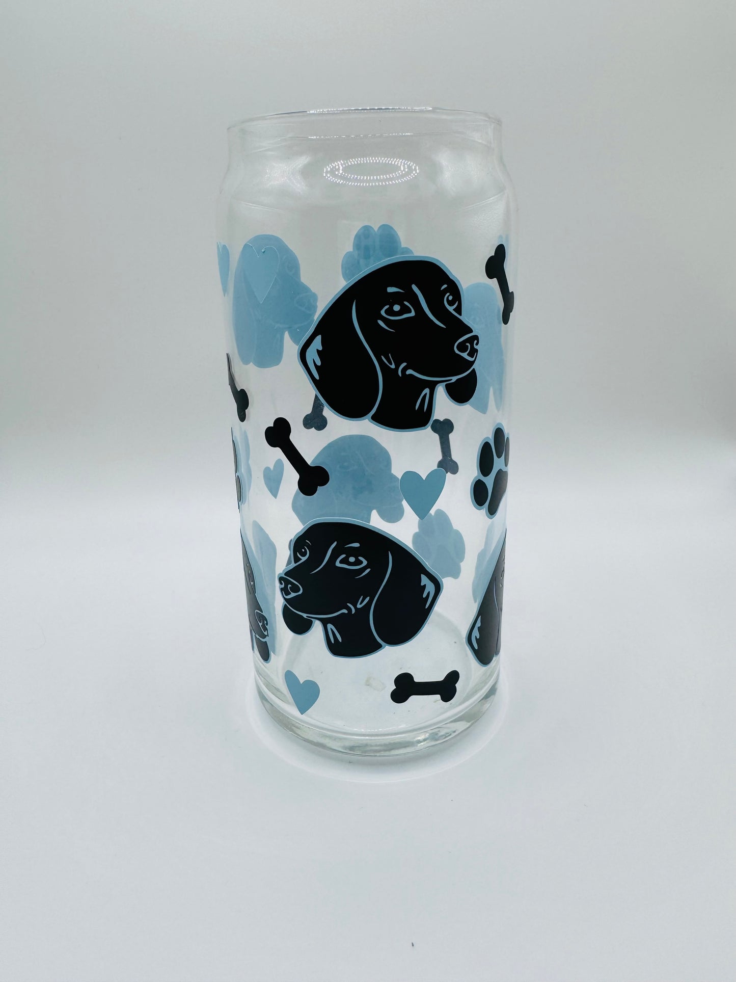 Daushund faces beer can glass