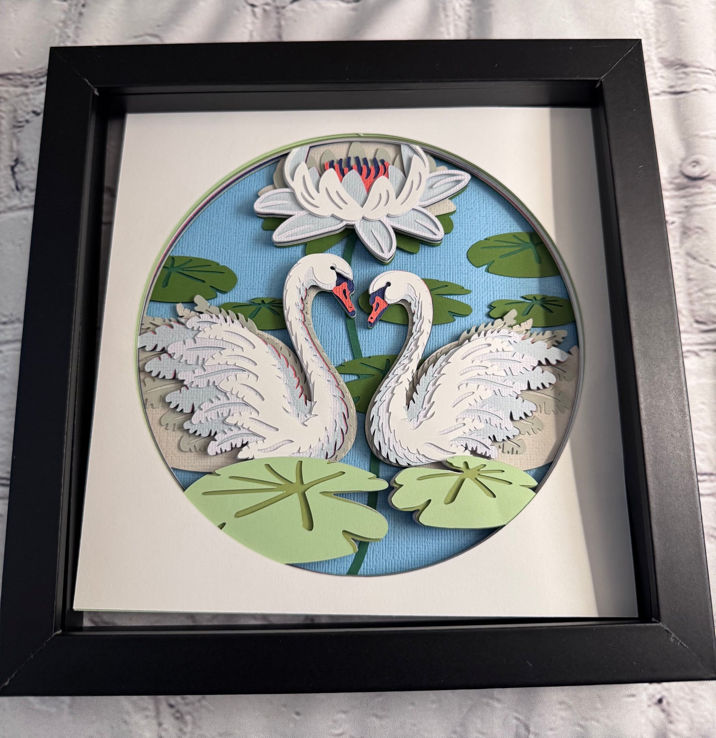 Swans on a lake 3D paper art in a shadowbox