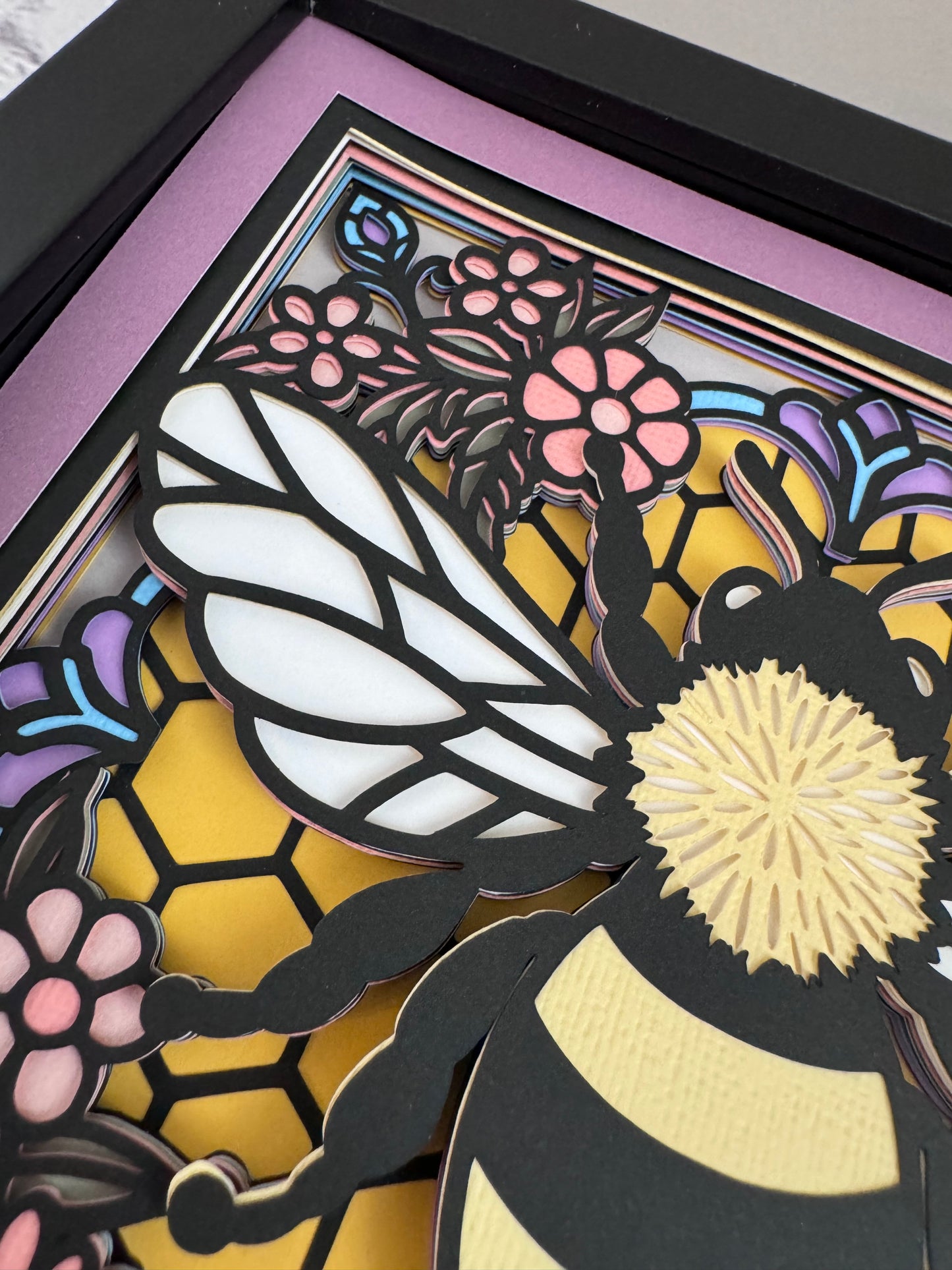 Colorful bee stained glass look 3D paper art in a shadowbox