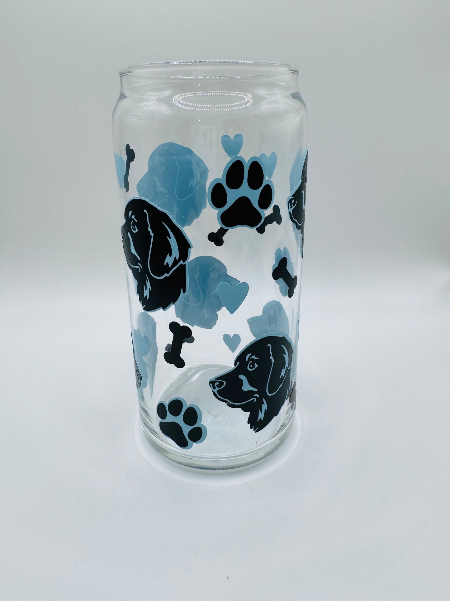Retriever faces beer can glass