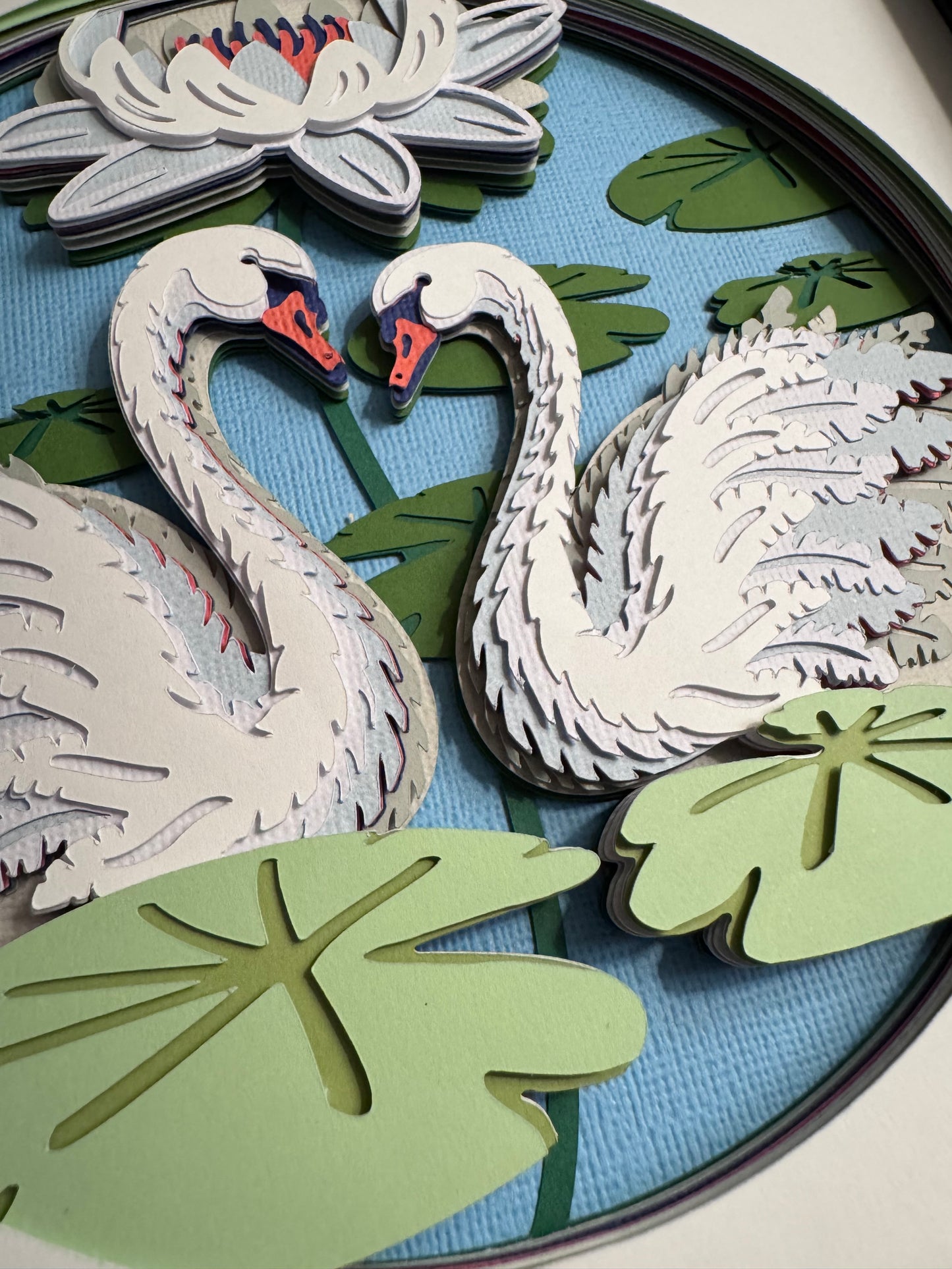 Swans on a lake 3D paper art in a shadowbox
