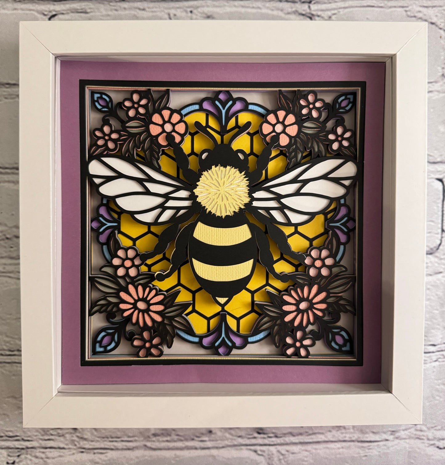 Colorful bee stained glass look 3D paper art in a shadowbox