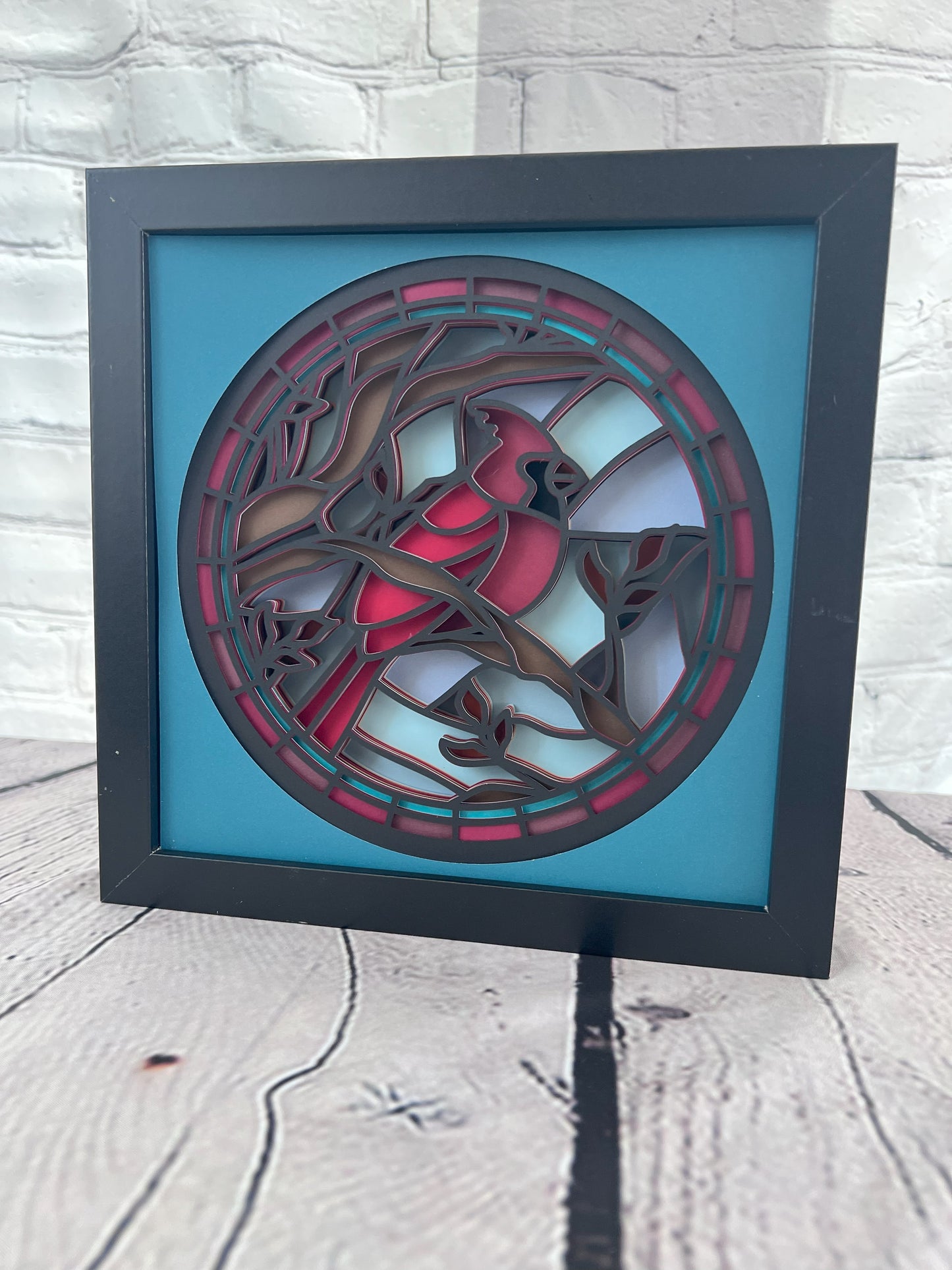 Stained glass cardinal 3D paper art in a shadowbox