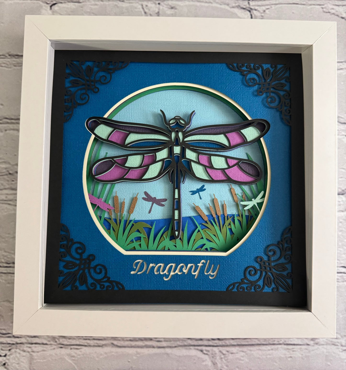 Intricate frame dragonfly 3D paper art in a shadowbox