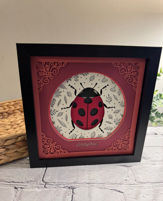 Intricate frame ladybug 3D paper art in a shadowbox