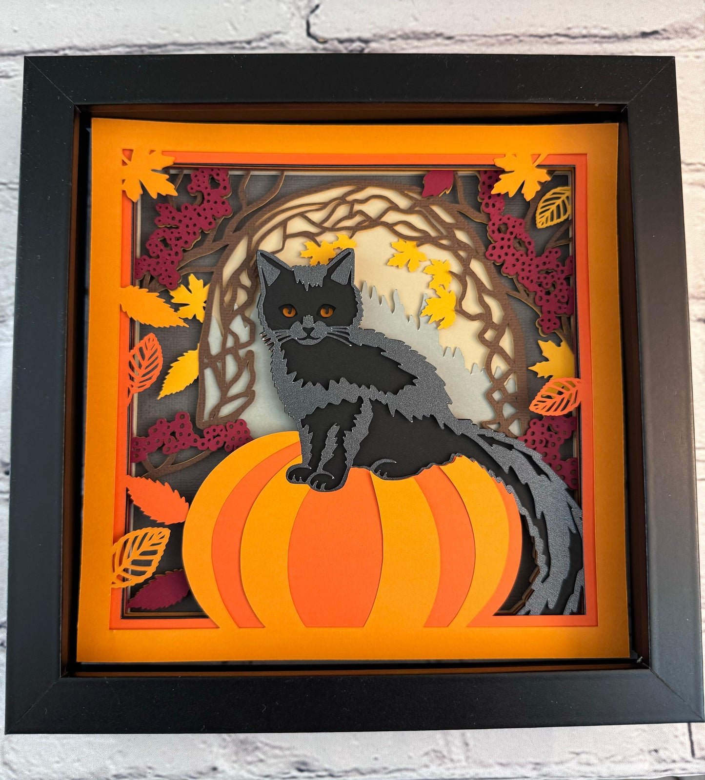 Black cat on a pumpkin 3D paper art in a shadowbox