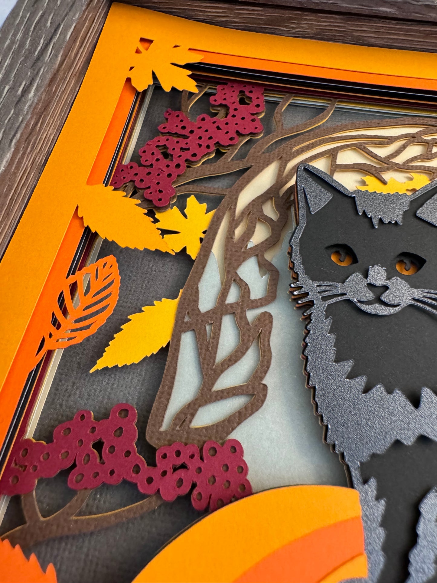 Black cat on a pumpkin 3D paper art in a shadowbox