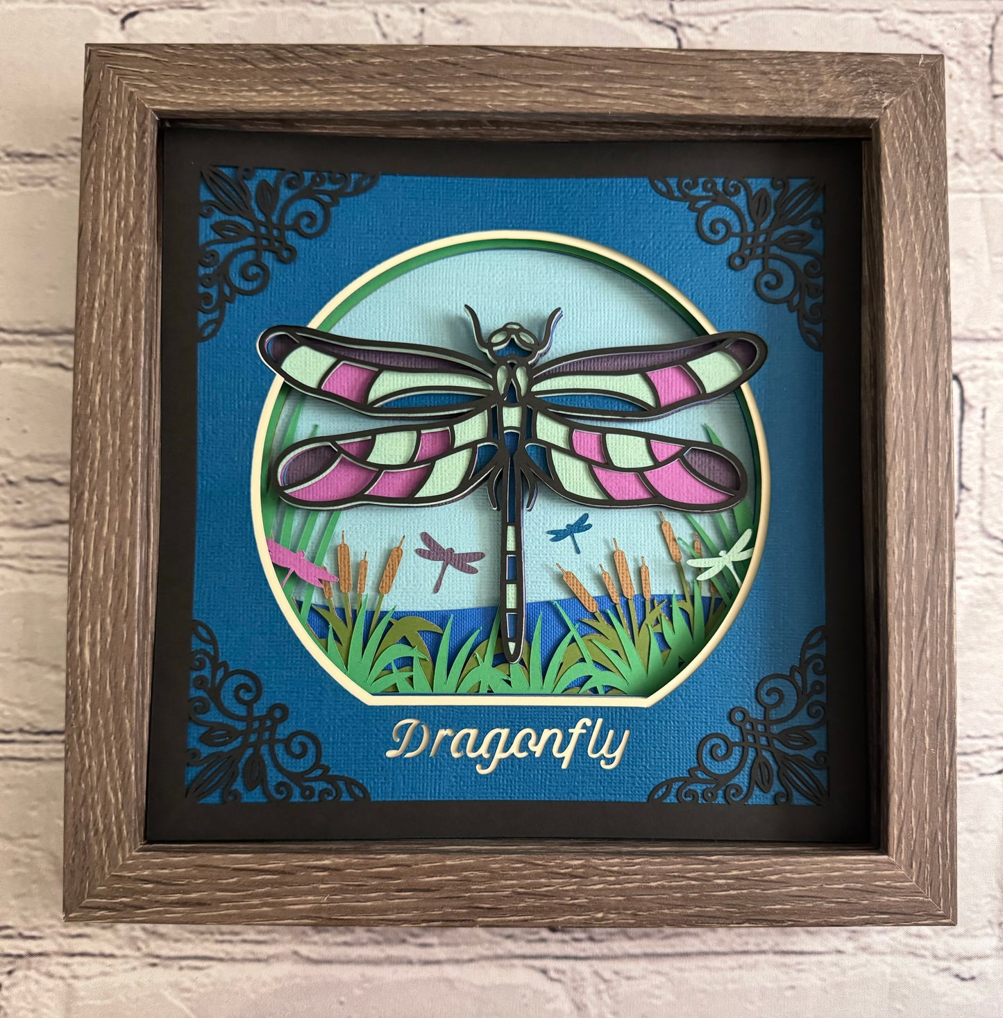 Intricate frame dragonfly 3D paper art in a shadowbox