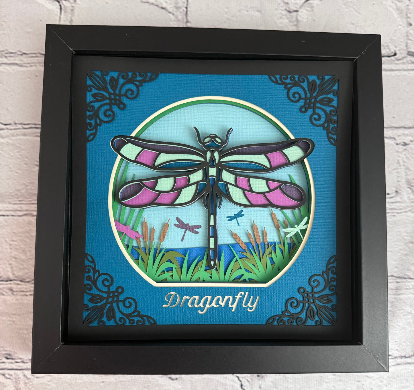 Intricate frame dragonfly 3D paper art in a shadowbox