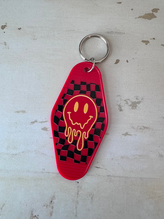 Melting smiley face retro motel keychain