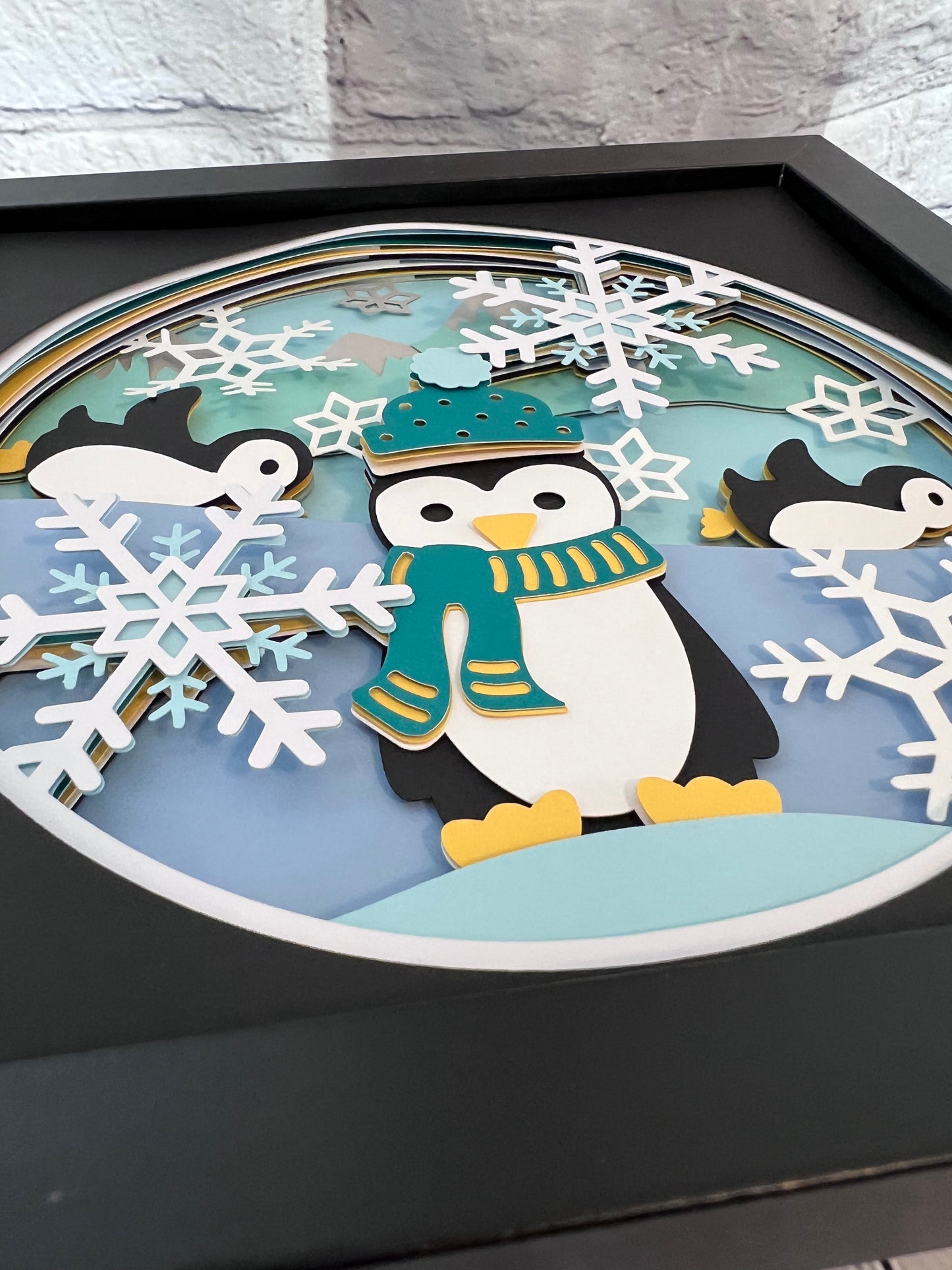 Penguins at play 3D paper art in a shadowbox