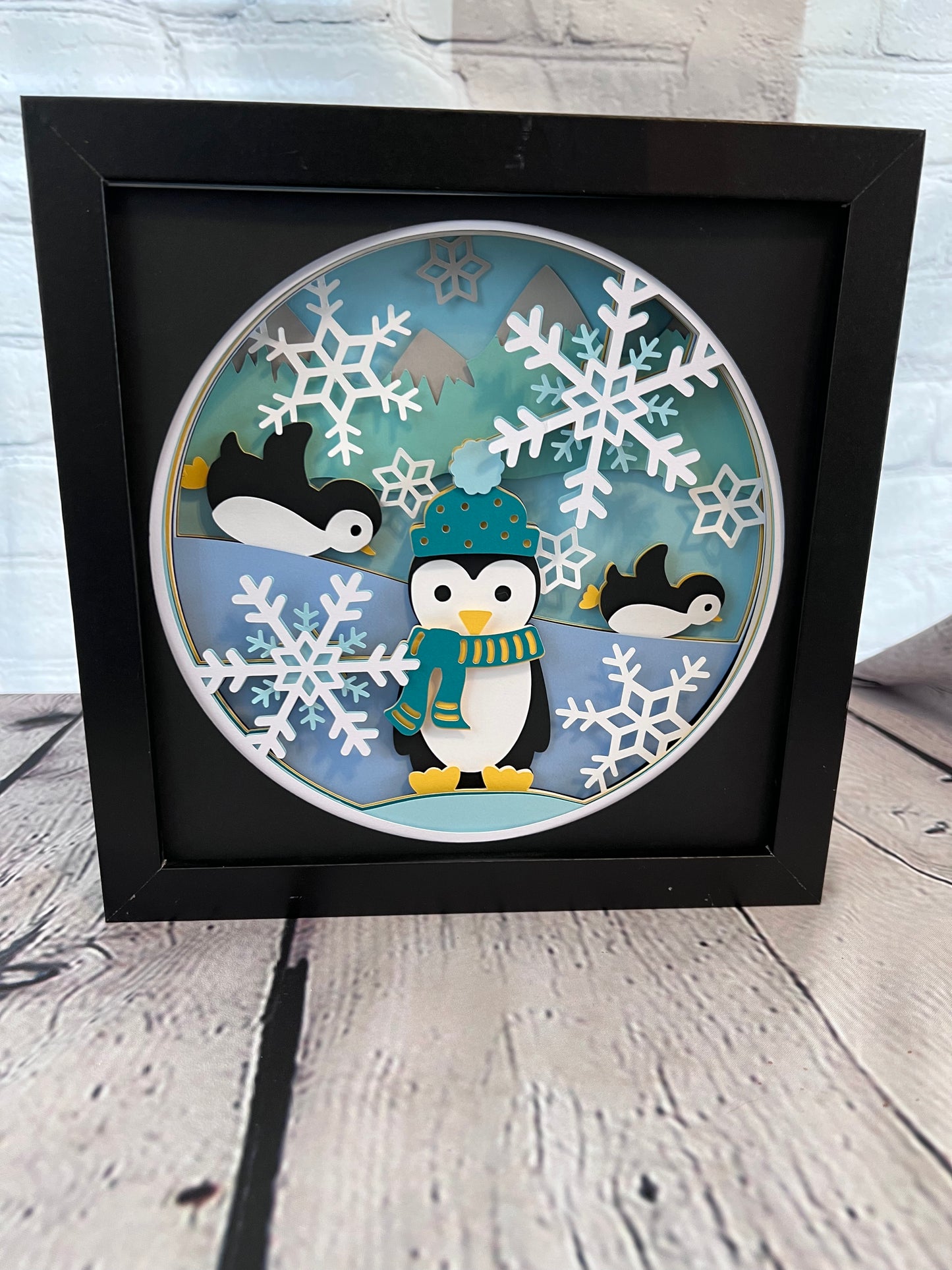 Penguins at play 3D paper art in a shadowbox